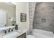 Bathroom featuring a granite countertop, framed mirror, and a shower with decorative curtain at 2330 Del Webb Gardens Dr, Fuquay Varina, NC 27526