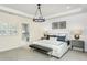 Bright and airy bedroom with a bench at the foot of the bed and an ensuite bathroom at 2330 Del Webb Gardens Dr, Fuquay Varina, NC 27526