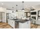 Spacious kitchen with a large island, stainless steel appliances, pantry, and seamless integration with the adjacent living area at 2330 Del Webb Gardens Dr, Fuquay Varina, NC 27526