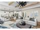 Open-concept living area seamlessly connects to a kitchen with stainless steel appliances and a comfortable seating area at 2330 Del Webb Gardens Dr, Fuquay Varina, NC 27526