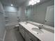 This bathroom offers dual sinks with quartz countertops and a tub and shower combo at 50 Calabria Ct, Franklinton, NC 27525