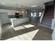 Open concept living room and kitchen with hardwood floors at 50 Calabria Ct, Franklinton, NC 27525