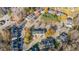 An aerial view of the neighborhood featuring tree-lined streets and the townhouses with parking spots at 526 Elm Ave, Wake Forest, NC 27587