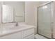 Clean bathroom with a white vanity, mirror, and a glass-enclosed shower, providing a functional space at 526 Elm Ave, Wake Forest, NC 27587