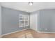 Well-lit bedroom with carpet and double door closet at 526 Elm Ave, Wake Forest, NC 27587