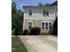 This two-story home has a neutral exterior with a concrete driveway and neatly trimmed landscaping at 526 Elm Ave, Wake Forest, NC 27587