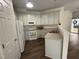 Well-equipped kitchen featuring white cabinets and vinyl flooring at 526 Elm Ave, Wake Forest, NC 27587