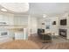 Open-concept living space with a fireplace, modern furnishings, and a view of the kitchen at 526 Elm Ave, Wake Forest, NC 27587