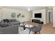 Inviting living room with neutral carpet, couch, chair, and contemporary decor, creating a cozy and modern atmosphere at 526 Elm Ave, Wake Forest, NC 27587
