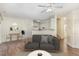 A modern living room with a cozy gray sofa, hardwood floors, and an adjacent kitchen area at 526 Elm Ave, Wake Forest, NC 27587
