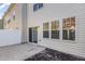 An outdoor patio featuring a sliding door and a view of the home's neutral siding and landscaping at 526 Elm Ave, Wake Forest, NC 27587