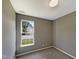 Bedroom with gray walls and carpeted floors, featuring a window that provides natural light at 6 Heatherford Ct, Durham, NC 27704