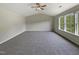 Large carpeted bedroom with neutral walls, vaulted ceiling, a ceiling fan, and natural light from the windows at 6 Heatherford Ct, Durham, NC 27704