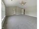 Large carpeted bedroom with neutral walls, vaulted ceiling, a ceiling fan, and natural light from the windows at 6 Heatherford Ct, Durham, NC 27704