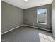 Bedroom showcasing neutral carpet, gray walls, and a window that offers lots of natural light at 6 Heatherford Ct, Durham, NC 27704