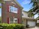 Charming two-story brick home with red shutters and a well-maintained front yard at 6 Heatherford Ct, Durham, NC 27704