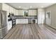 Modern kitchen features white cabinets, stainless steel appliances, and hardwood floors at 6 Heatherford Ct, Durham, NC 27704