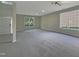 Spacious carpeted living room with natural light coming in from the large windows at 6 Heatherford Ct, Durham, NC 27704