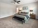 Main bedroom with ceiling fan, carpeted floor, and large windows at 8817 Melvin St # 27, Willow Springs, NC 27592