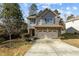 Two-story house with gray siding, brick accents, and a two-car garage at 1219 Shining Water Ln, Creedmoor, NC 27522