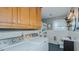 A combined laundry and bathroom with vintage oak cabinets and stylish white tile and fixtures at 2434 Orice St, Burlington, NC 27215