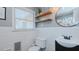 A cozy bathroom offers a modern sink, decorative shelves, and ample natural light at 2434 Orice St, Burlington, NC 27215