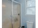 Bathroom featuring a sliding glass door shower, toilet, and window for natural light at 2434 Orice St, Burlington, NC 27215