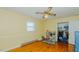 A sunny yellow bedroom with a spacious closet, hardwood floors, and a ceiling fan for comfort at 2434 Orice St, Burlington, NC 27215