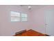 A snug bedroom featuring hardwood floors, a ceiling fan, and a window that lets in plenty of natural light at 2434 Orice St, Burlington, NC 27215