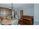 Classic dining room featuring hardwood floors, wooden table, and a vintage piano at 2434 Orice St, Burlington, NC 27215