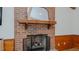 Close-up of the living room's brick fireplace, complete with a mantel and decorative accents at 2434 Orice St, Burlington, NC 27215