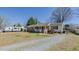 Spacious front yard with a charming single-story home, featuring brick and vinyl siding, and a cozy front porch at 2434 Orice St, Burlington, NC 27215