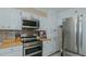 Stylish kitchen featuring stainless steel appliances, white cabinetry, and contemporary backsplash at 2434 Orice St, Burlington, NC 27215
