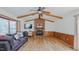 Bright living room featuring vaulted ceilings, exposed wood beams, a brick fireplace, and modern flooring at 2434 Orice St, Burlington, NC 27215