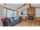 Bright living room showcasing vaulted ceilings, a cozy sofa, and a beautiful brick fireplace at 2434 Orice St, Burlington, NC 27215