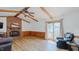 Open living room with a cozy fireplace, wood-look floors, and a sliding glass door to the outdoor space at 2434 Orice St, Burlington, NC 27215