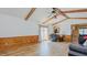 Spacious living room featuring exposed beam ceilings, updated flooring, and a comfortable seating area at 2434 Orice St, Burlington, NC 27215