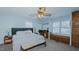 Bright primary bedroom with neutral carpet, desk, built-in cabinets, and natural light from two windows at 2434 Orice St, Burlington, NC 27215