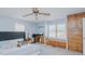 Spacious primary bedroom featuring built-in cabinets, a ceiling fan, desk, and abundant natural light at 2434 Orice St, Burlington, NC 27215