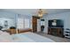 A roomy primary bedroom boasts neutral carpet, built-ins, a fireplace, and lots of sunlight at 2434 Orice St, Burlington, NC 27215