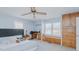 Spacious primary bedroom featuring built-in cabinets, a ceiling fan, desk, and abundant natural light at 2434 Orice St, Burlington, NC 27215