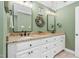 Double vanity bathroom with granite countertops and green walls at 4027 Green Forest Ct, Rocky Mount, NC 27804
