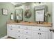 Double vanity bathroom with granite countertops and green walls at 4027 Green Forest Ct, Rocky Mount, NC 27804