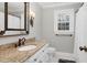 Bathroom features granite countertop, white cabinets, and a window at 4027 Green Forest Ct, Rocky Mount, NC 27804