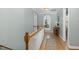 Upper hallway with hardwood floors, arched window, and tasteful decor at 4027 Green Forest Ct, Rocky Mount, NC 27804