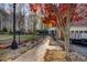 Brick walkway leads to a screened porch and garage, framed by colorful autumn trees at 4027 Green Forest Ct, Rocky Mount, NC 27804