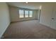 Carpeted bedroom with three large windows providing ample natural light at 424 La Maison Ave # 9, Wendell, NC 27591