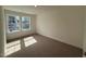 Carpeted bedroom with natural light shining through two windows at 424 La Maison Ave # 9, Wendell, NC 27591