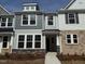 New townhome exterior showing stone accents, painted siding, and large picture windows at 424 La Maison Ave # 9, Wendell, NC 27591