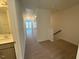 Upstairs hallway with carpet, several doors, and a view to a bedroom at 424 La Maison Ave # 9, Wendell, NC 27591